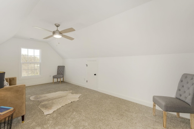 sitting room with ceiling fan, carpet flooring, and vaulted ceiling