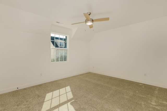 carpeted spare room with lofted ceiling and ceiling fan