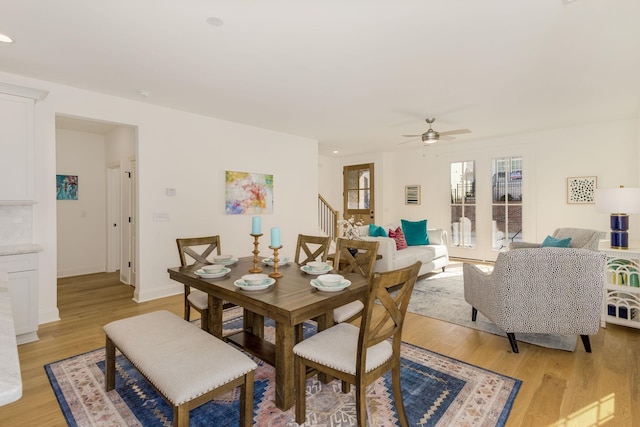 dining room with light hardwood / wood-style floors and ceiling fan