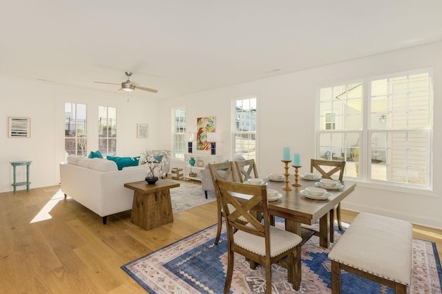 dining space featuring ceiling fan, light hardwood / wood-style floors, and a healthy amount of sunlight