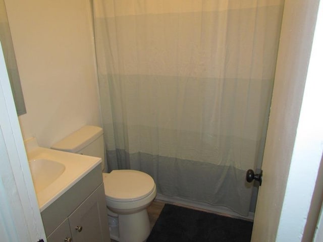 bathroom with vanity, a shower with curtain, and toilet