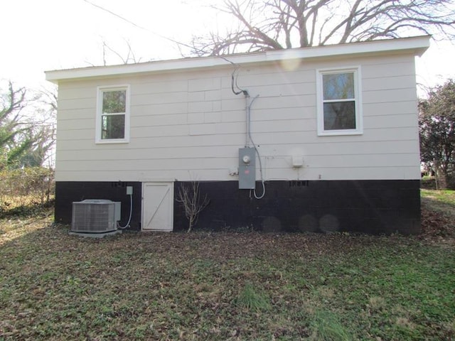 view of side of property featuring central AC