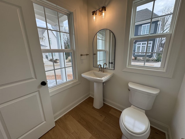 bathroom featuring hardwood / wood-style flooring and toilet