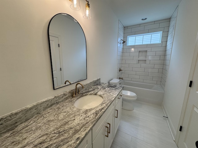 full bathroom with vanity, toilet, and tiled shower / bath combo