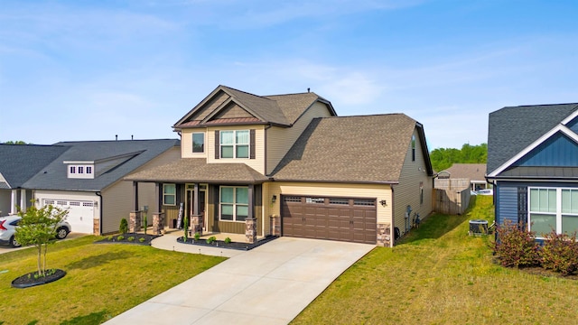 craftsman house featuring a porch, a garage, a front yard, and central air condition unit