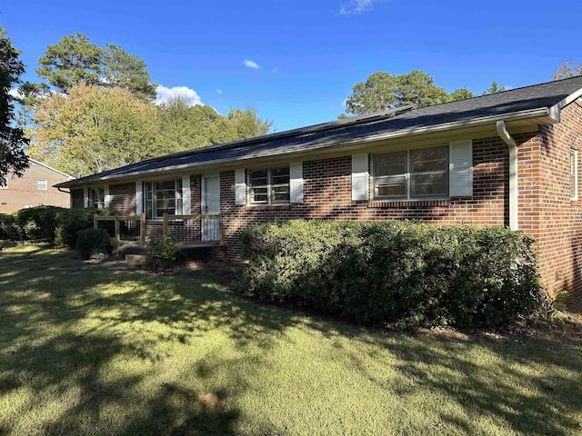 ranch-style house with a front lawn