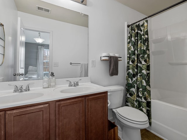 full bathroom with vanity, shower / bath combo, and toilet