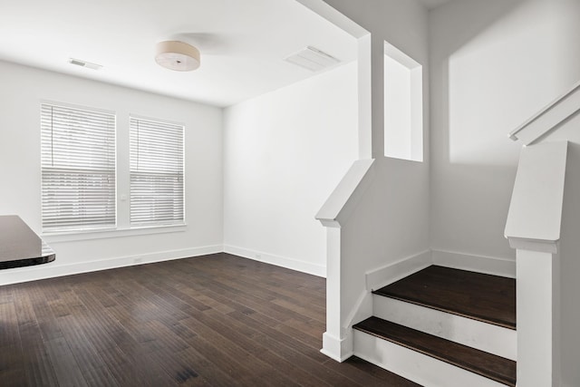 stairway with hardwood / wood-style flooring