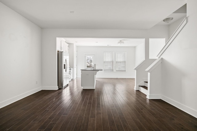 unfurnished living room featuring dark wood-type flooring