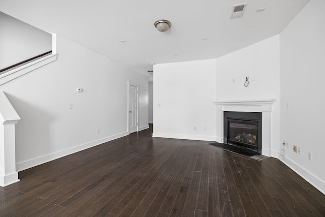 unfurnished living room featuring dark hardwood / wood-style floors