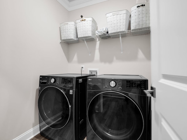 laundry room with hardwood / wood-style flooring, crown molding, and independent washer and dryer