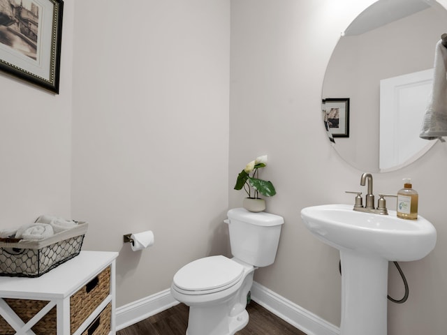 bathroom featuring sink, wood-type flooring, and toilet