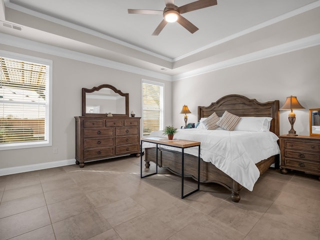 tiled bedroom with crown molding, ceiling fan, and a tray ceiling