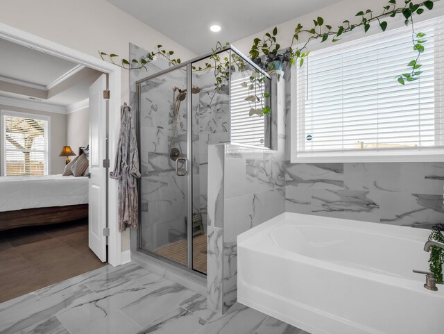 bathroom with crown molding and separate shower and tub