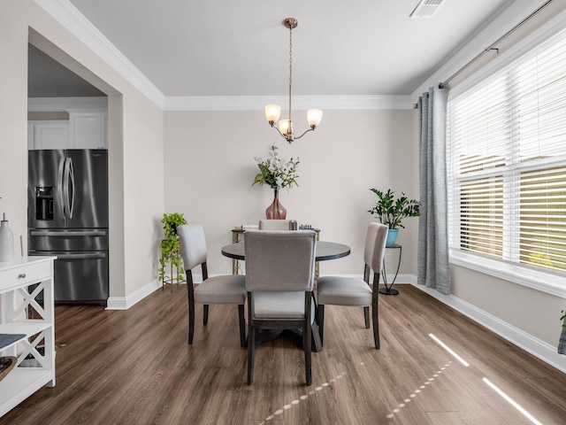 dining room with dark hardwood / wood-style flooring, ornamental molding, and a healthy amount of sunlight