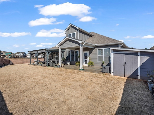 rear view of house featuring a patio, a storage unit, a lawn, and a pergola