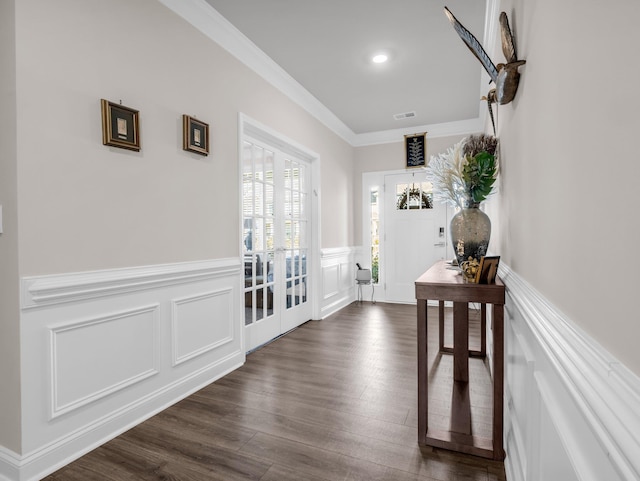 hallway with ornamental molding, dark wood-type flooring, and french doors