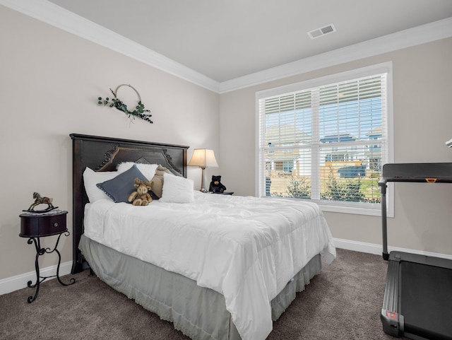 bedroom with ornamental molding and carpet floors