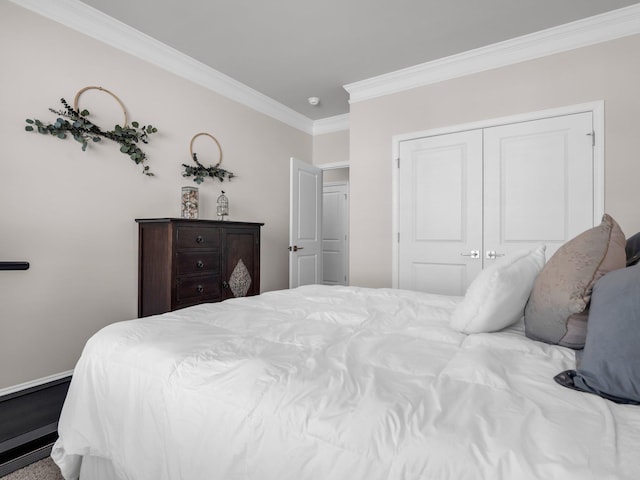 bedroom featuring hardwood / wood-style flooring, ornamental molding, and a closet