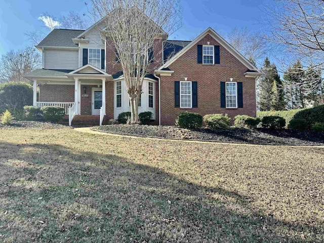 front of property featuring a front yard and covered porch