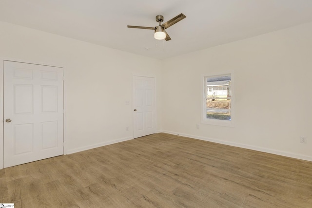 unfurnished room featuring ceiling fan and light wood-type flooring