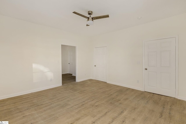 empty room with ceiling fan and light wood-type flooring