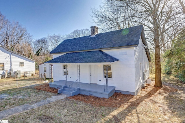 rear view of property featuring a porch