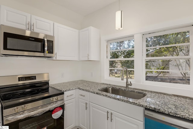 kitchen featuring sink, stainless steel appliances, and white cabinets