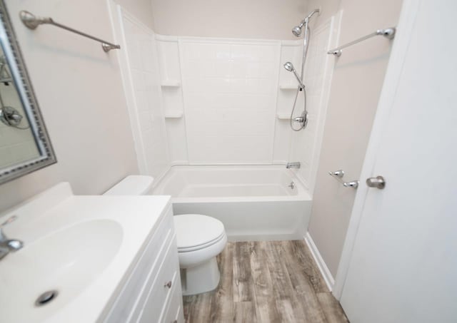 full bathroom with wood-type flooring, toilet, shower / washtub combination, and vanity