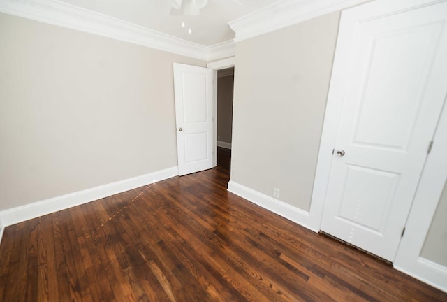 unfurnished bedroom with ornamental molding, dark hardwood / wood-style floors, and ceiling fan
