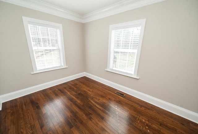 empty room featuring crown molding and hardwood / wood-style flooring