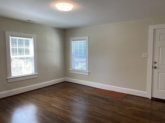 empty room featuring dark hardwood / wood-style flooring