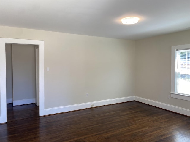 spare room with dark hardwood / wood-style floors