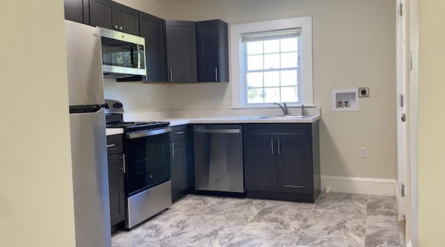 kitchen with sink and appliances with stainless steel finishes