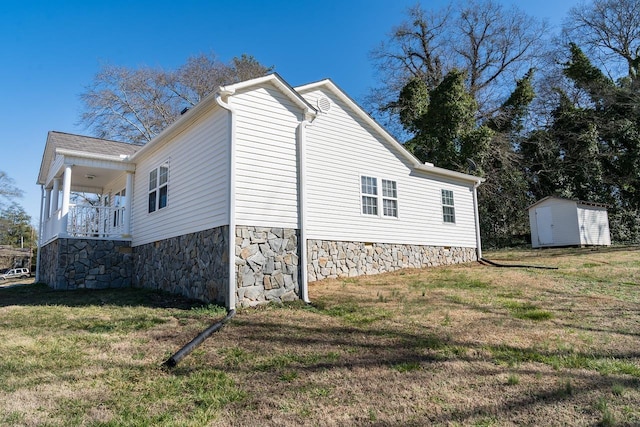 view of side of property featuring a yard and a shed