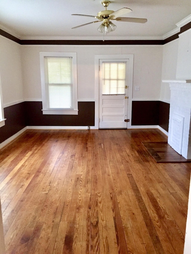 unfurnished room featuring hardwood / wood-style flooring, ornamental molding, and ceiling fan
