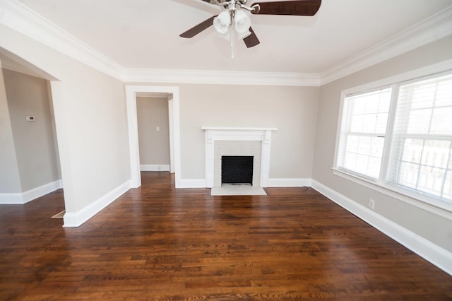 unfurnished living room featuring crown molding, a brick fireplace, dark hardwood / wood-style floors, and ceiling fan