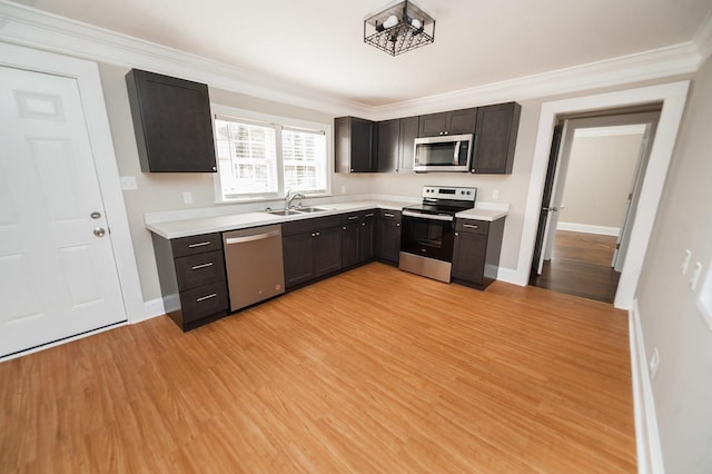 kitchen featuring dark brown cabinets, light wood-type flooring, and appliances with stainless steel finishes
