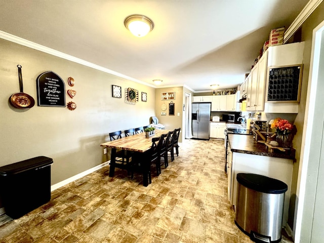 dining area featuring crown molding