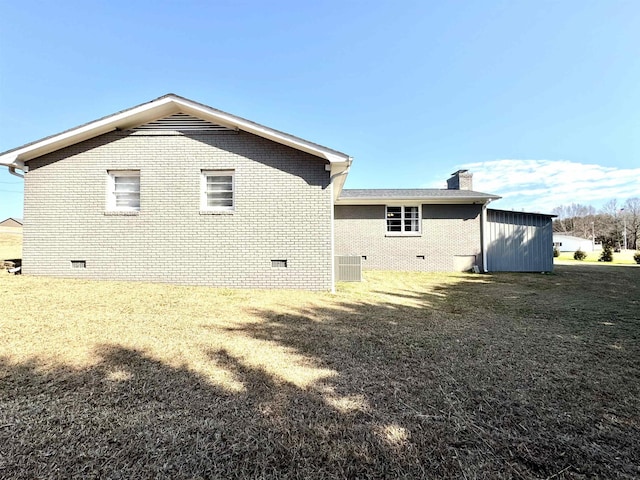 view of side of home with a yard