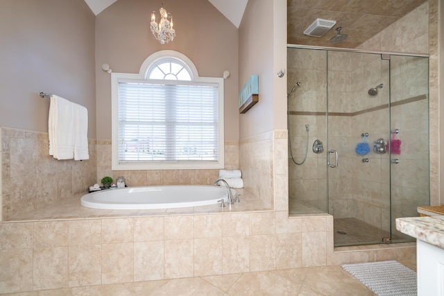 bathroom featuring vanity, a wealth of natural light, vaulted ceiling, and independent shower and bath