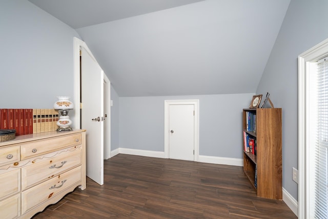 additional living space featuring dark hardwood / wood-style floors and vaulted ceiling