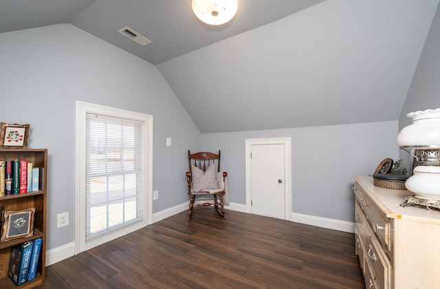 sitting room featuring dark hardwood / wood-style floors and vaulted ceiling