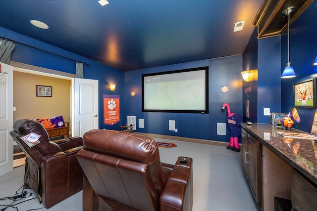 home theater room with light colored carpet