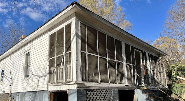 view of side of property with a sunroom