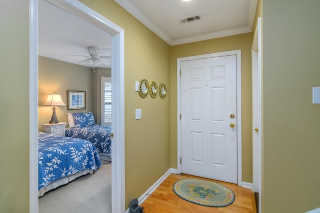 doorway to outside with ornamental molding, hardwood / wood-style floors, and ceiling fan