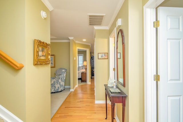 hall with ornamental molding and light wood-type flooring