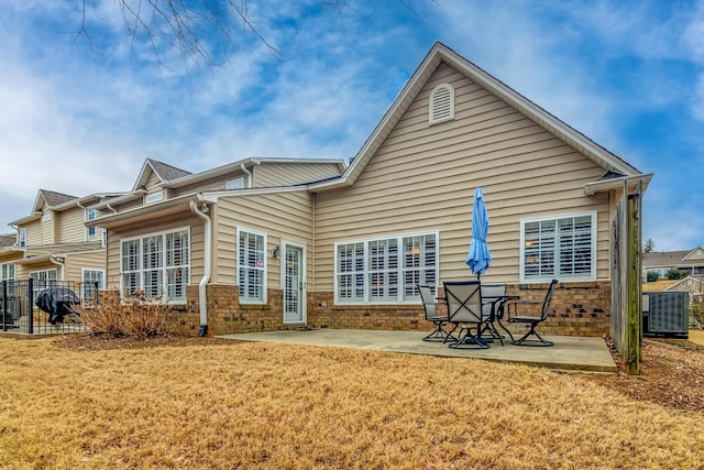 rear view of property featuring cooling unit, a patio area, and a lawn