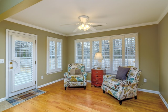 sitting room featuring ceiling fan, ornamental molding, and light hardwood / wood-style flooring