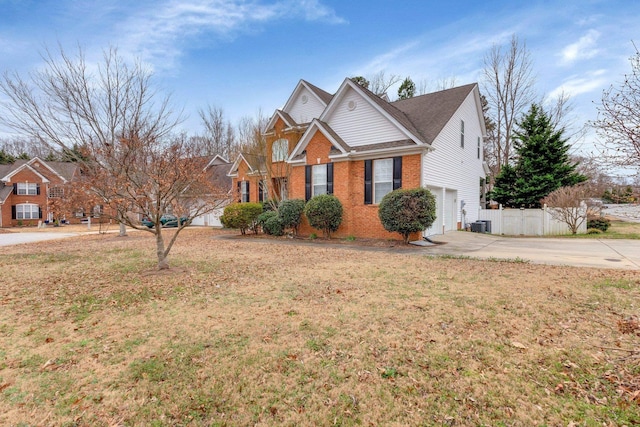 view of front of house featuring a garage, central AC, and a front yard